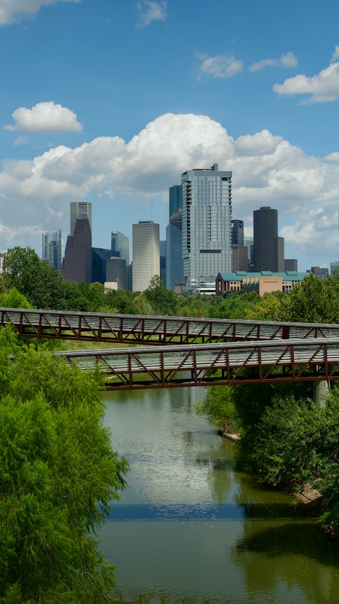 Beautiful view of Houston skyline with bridge over tranquil river.
